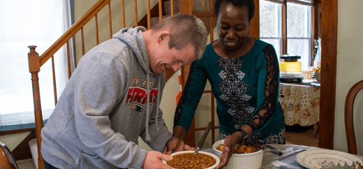 Image of two people cooking together